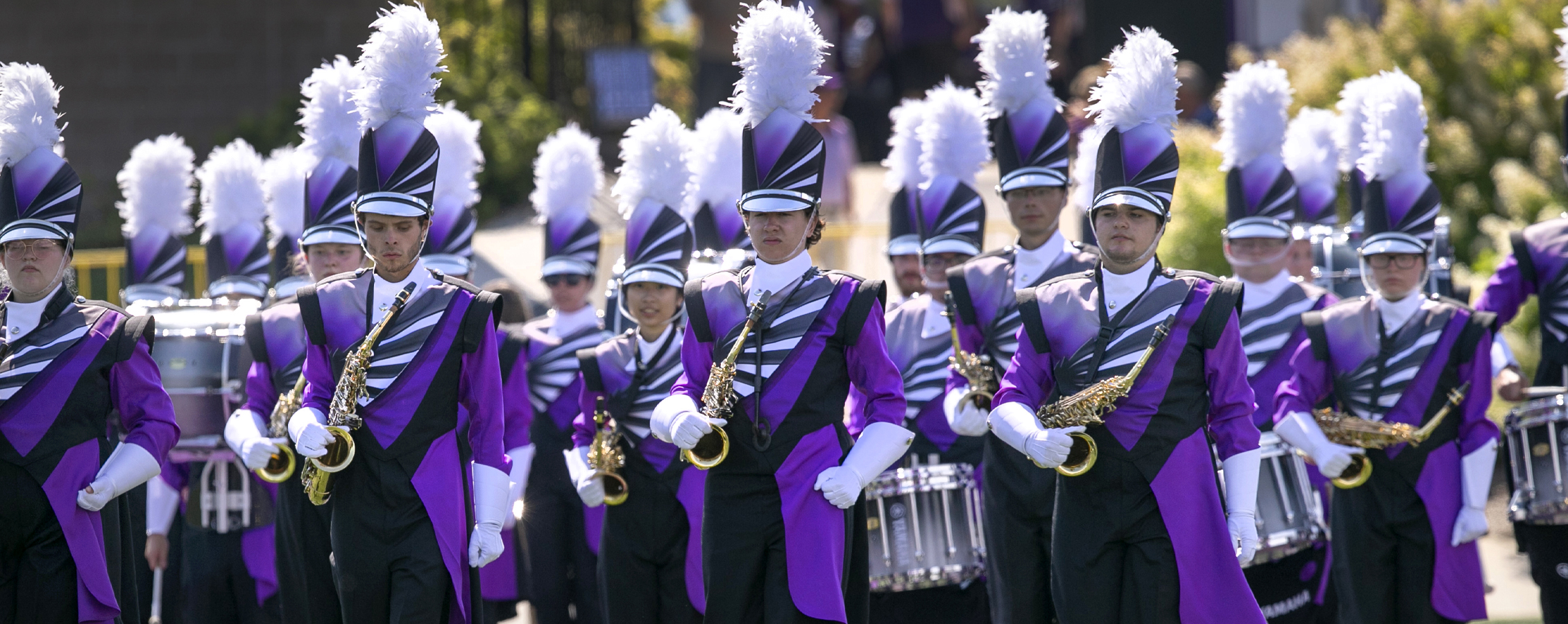 The Marching Band stands at attention in full uniform.